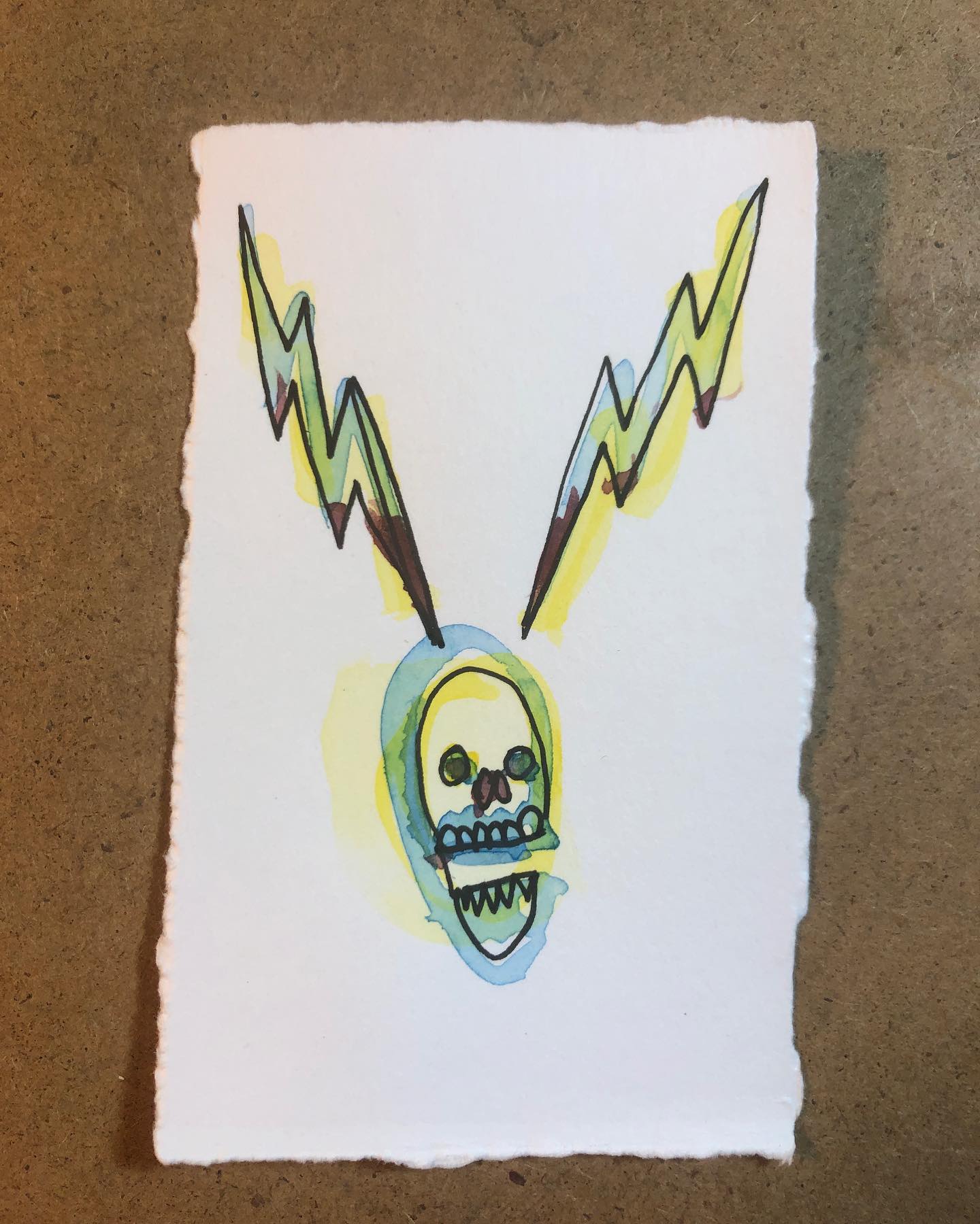 Watercolor and ink drawing of a skull/head with lighning bolts projecting from either side of the head