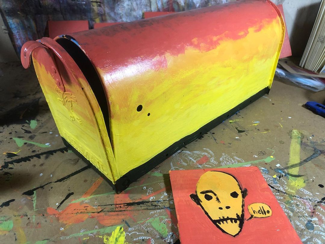 Sunset painting in progress on a mailbox