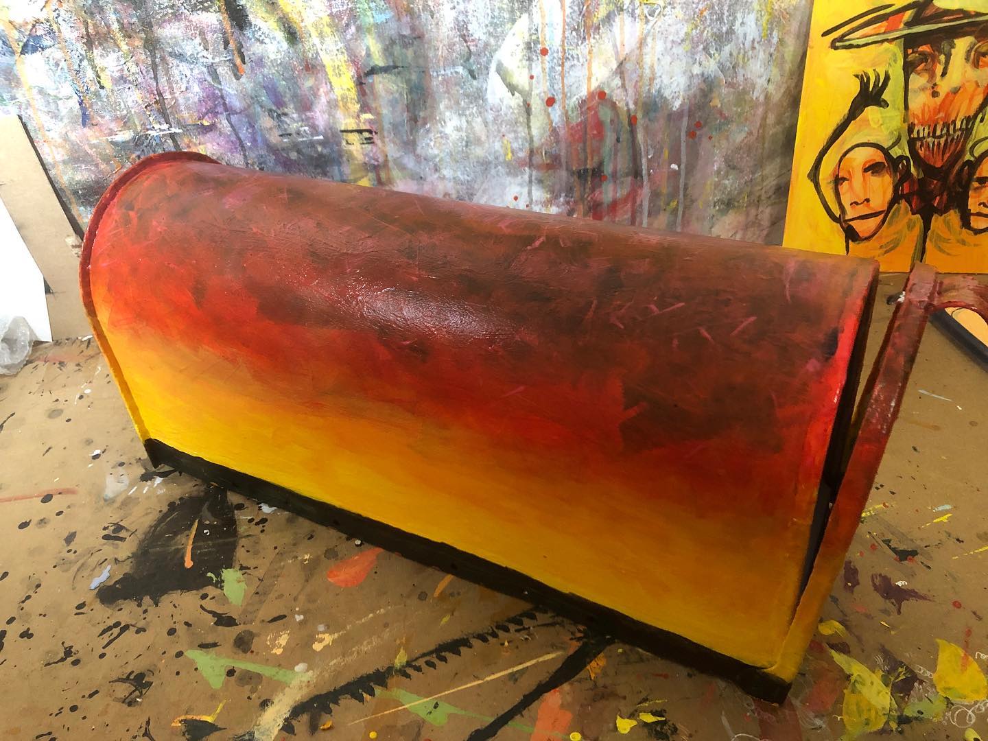 Acrylic painting of a sunset in progress on a mailbox