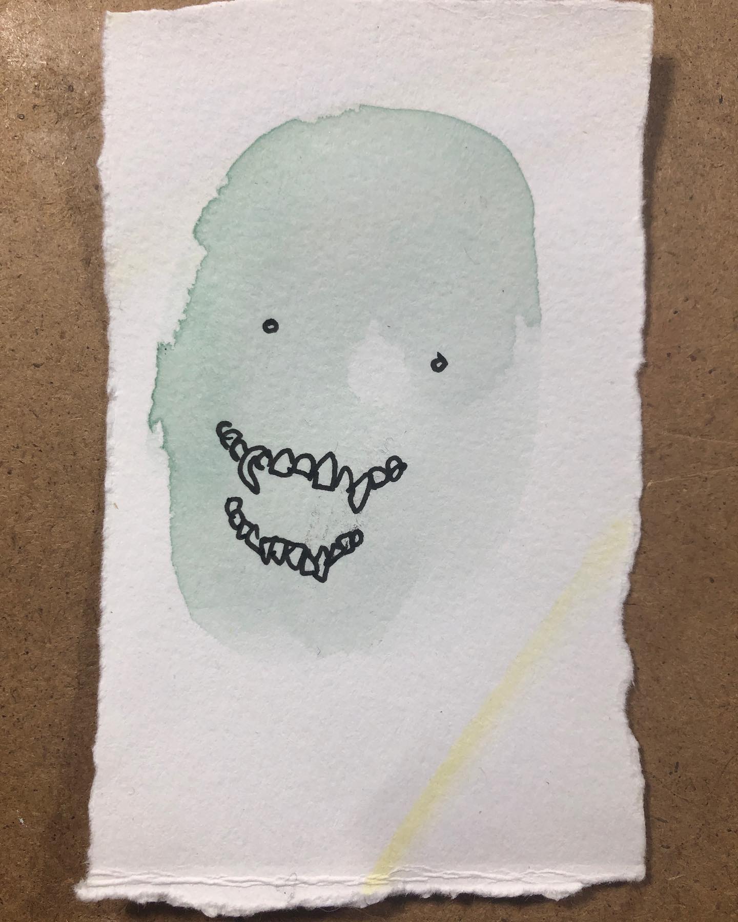 Spook drawing - green watercolor head with ink eyes and teeth
