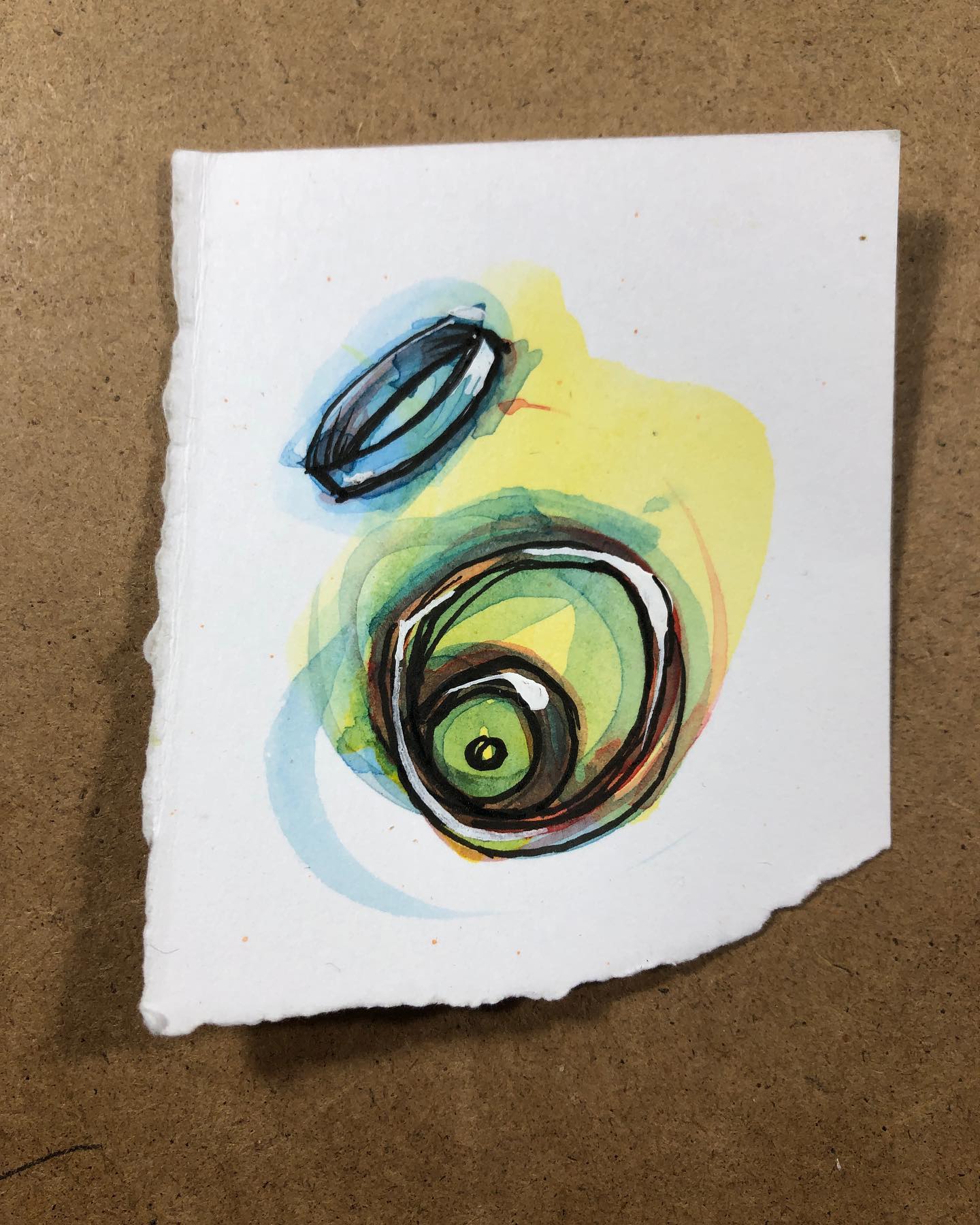 Eyeball HulaHoopery - ink and watercolor drawing of what appears to be an eyeball hooping a halo
