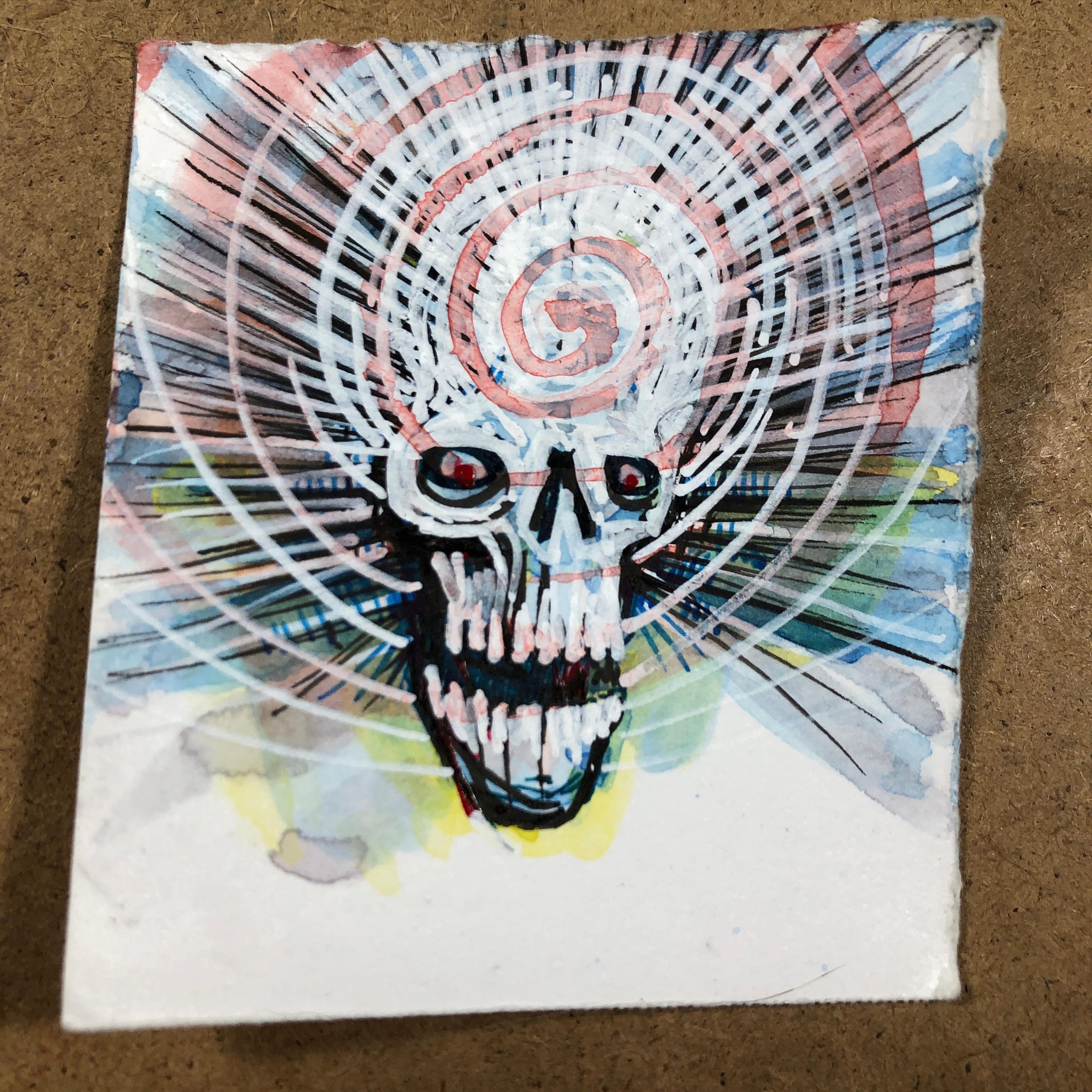 Ink and Watercolor drawing of a skull radiating some wild forces and auras with a red spiral overlay
