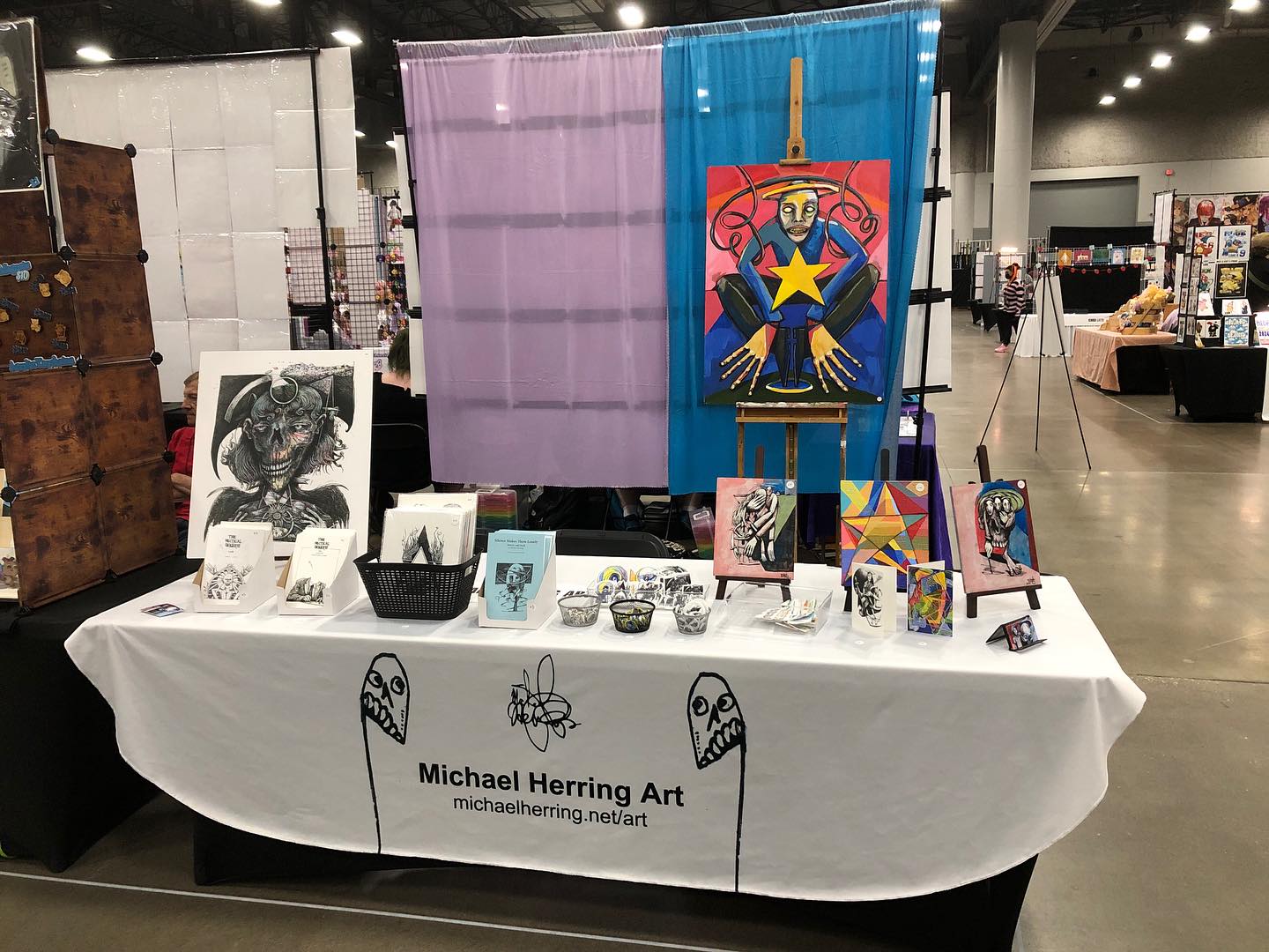 My table at Des Moines Con 2024 - Prints, paintings, zines, and stickers