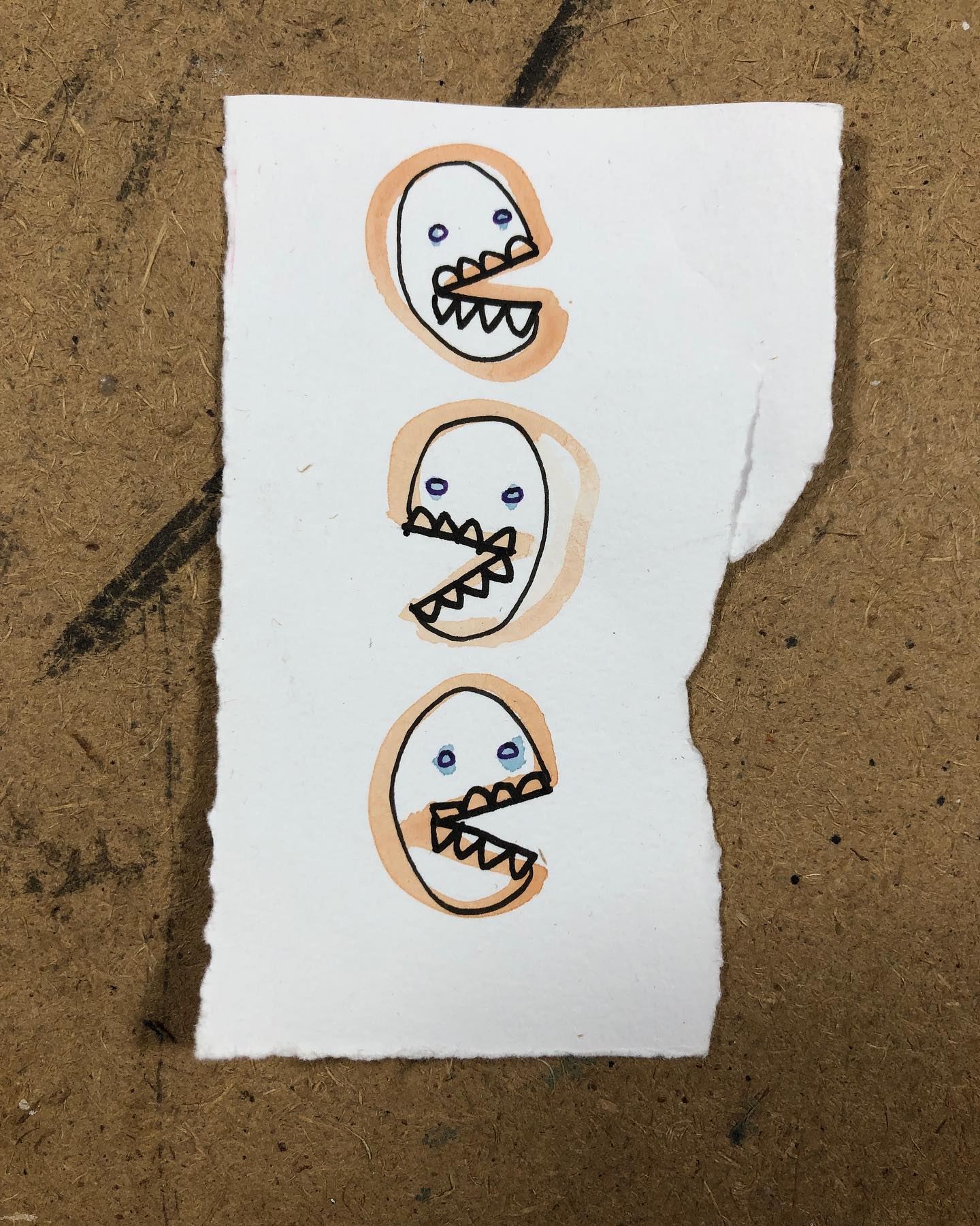 Ink and watercolor drawing of three skully heads on top of each other